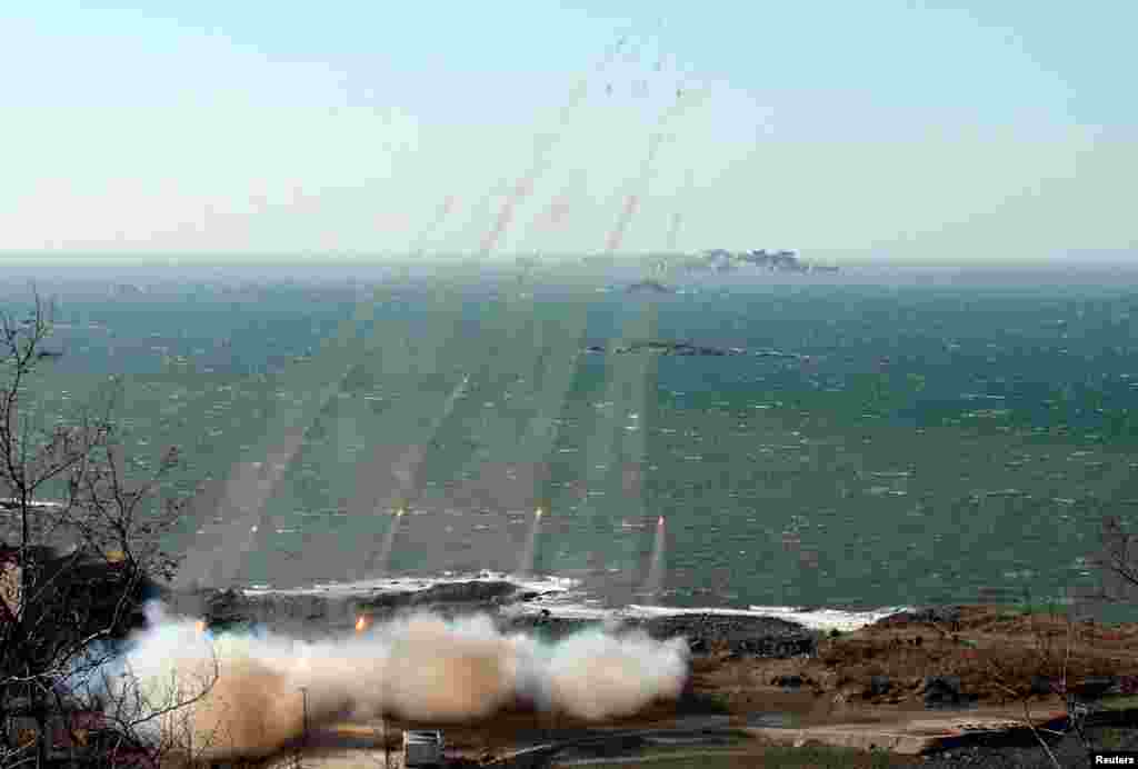 North Korea's artillery sub-units, whose mission is to strike Daeyeonpyeong island and Baengnyeong island of South Korea, conduct a live shell firing drill to examine war fighting capabilities in the western sector of the front line, March 14, 2013.