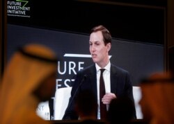 Participants watch U.S. White House senior adviser Jared Kushner on a screen during his speech in Riyadh, Saudi Arabia, Oct. 29, 2019.