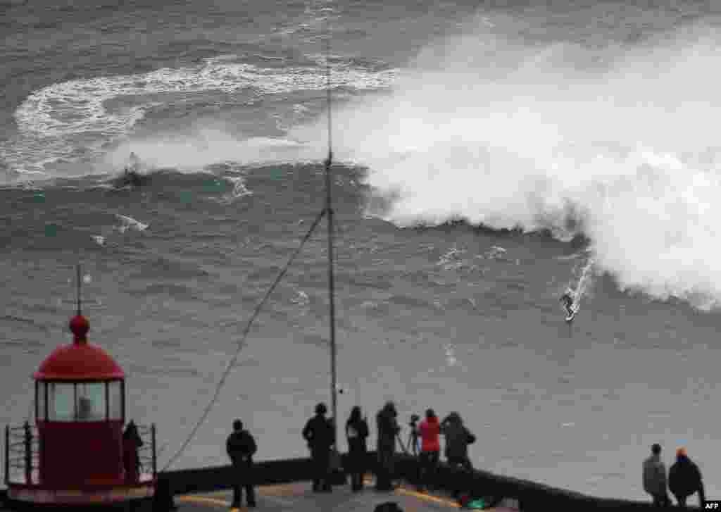Brazilian big wave surfer Carlos Burle rides a wave in Nazare, central Portugal.