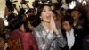 Thailand's former Prime Minister Yingluck Shinawatra, center, leaves parliament in Bangkok, Jan. 22, 2015.