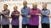 President Barack Obama and Myanmar President Thein Sein, second from left, pose during the East Asia Summit family photo at the Myanmar International Convention Center, Nov. 12, 2014, in Naypyitaw, Myanmar.