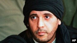 FILE - Hannibal Gadhafi, son of late Libyan leader Moammar Gadhafi, watches an elite military unit exercise in Zlitan, Libya, in this undated file photo made available Sept. 25, 2011.
