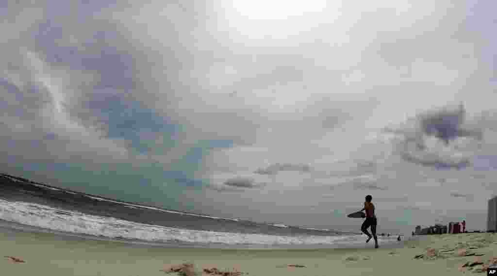 A boy plays in the surf in waves ahead of Tropical Storm Isaac in Orange Beach, Ala., Aug. 27, 2012. 