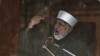 Sufi cleric and leader of the Minhaj-ul-Quran religious organisation Muhammad Tahirul Qadri addresses his supporters from behind the window of an armored vehicle on the second day of protests in Islamabad, January 15, 2013.
