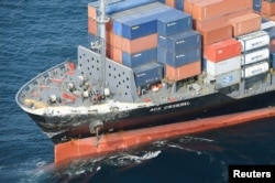 A Philippine-flagged merchant vessel, damaged by colliding with the Arleigh Burke-class guided-missile destroyer USS Fitzgerald, is seen off Izu Oshima island, Japan, June 17, 2017, in this photo taken by Kyodo.