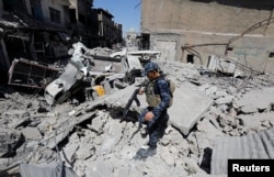 A member of Iraqi federal police patrols in the destroyed Old City of Mosul, Iraq, Aug. 7, 2017.