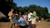 Crosby Menzies shows one of his SunFire solar cookers to villagers in Zambia (SunFire)