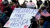 FILE - Supporters of immigrants' rights march in downtown Washington during an immigration protest, Feb. 16, 2017. A group of Hispanic workers is suing a Michigan industrial plant that fired them for taking part in the protest.