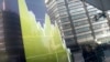 Pedestrians are reflected in an electronic stock chart showing Japan's Nikkei 225 at a securities firm in Tokyo, Tuesday, Feb. 9, 2016.
