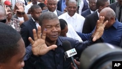 FILE - Joao Lourenco shows his ink-stained finger as he faces the media after casting his vote in elections in Luanda, Angola, Aug. 23, 2017.