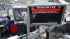 In this photo by Kyodo, a TV in Tokyo, April 13, 2023 displays a warning message that reads: Japanese government warns citizens of the northernmost main island of Hokkaido to take immediate cover and stay inside buildings, saying a missile was likely to fall near the island.