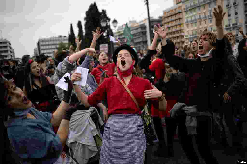 People dance and sing during a demonstration to mark International Women&#39;s Day in front of the parliament building in Athens, Greece.