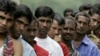 FILE - Bangladeshi migrant workers wait in line for food donated by a goodwill charity group for Christmas outside the Bangladeshi High Commission in Kuala Lumpur, Malaysia, Dec. 25, 2007.