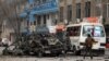 FILE - Afghan security personnel inspect the site of a bomb attack in Kabul, Afghanistan, Dec. 26, 2020. 