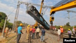 A damaged coach of a passenger train is removed after it derailed near Kuneru village in Vizianagaram district, in the southern state of Andhra Pradesh, India, Jan. 22, 2017. 