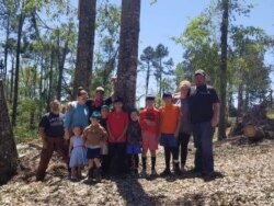 David Lay (right), his volunteer crew and family stand at the spot where fellow volunteer, Patrick Hadley passed away while helping victims of recent tornadoes in Mississippi. (Courtesy: United Cajun Navy)