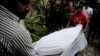 The body of Italian citizen Cesare Tavella, who was gunned down by unidentified assailants, is carried out of a hospital morgue in Dhaka, Bangladesh, Oct. 14, 2015. 