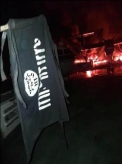 FILE - An image distributed by al-Shabaab after the attack on a military base in Kenya shows Somalia's al-Shabaab militant group's flag, said to be at the Manda Bay Airfield in Manda, Lamu, Kenya, Jan. 5, 2020.