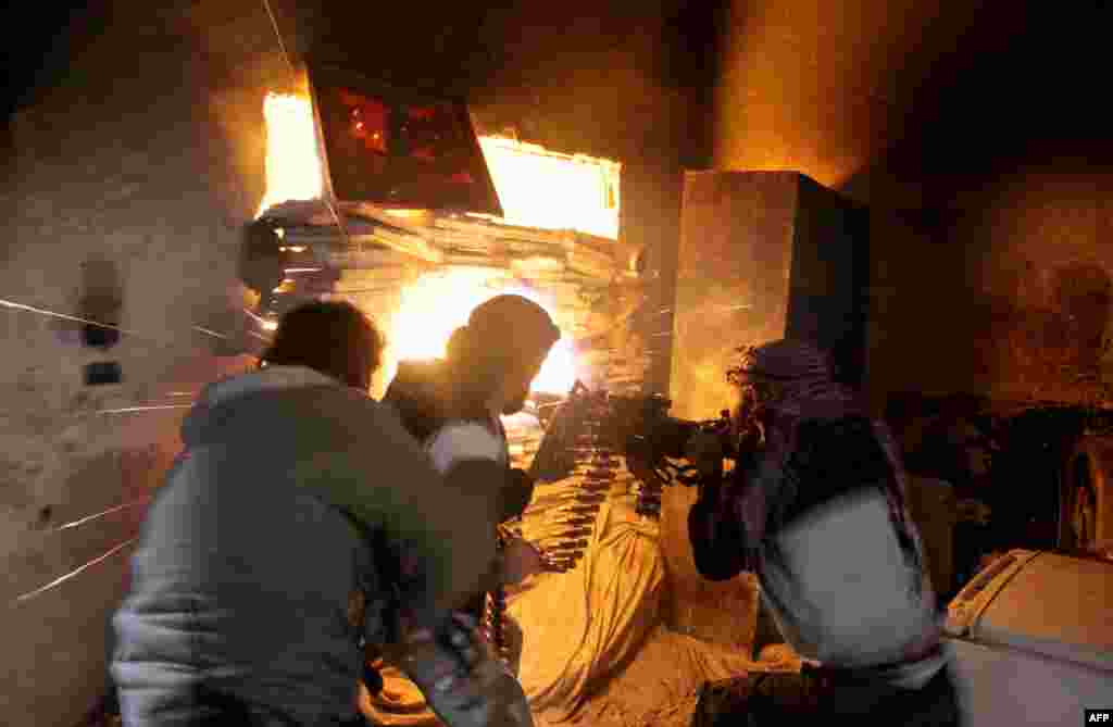 Rebel fighters from the Free Syrian Army fire a heavy machine gun during fighting against government forces in the Salah al-Din neighbourhood of the northern Syrian city of Aleppo.