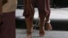 FILE - The shackled legs of suspected human traffickers are seen as they arrive for their trial at the criminal court in Bangkok, Thailand, March 15, 2016.