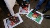 Indian protesters stamp placards with pictures of Pakistani Mujahiddeen leader Masood Azhar, left, as they condemn the attack on the Pathankot air force base in Mumbai, India, Jan.4, 2016. 