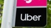 FILE PHOTO: A sign marks a rendezvous location for Lyft and Uber users at San Diego State University in San Diego, California, U.S., May 13, 2020. REUTERS/Mike Blake/File Photo