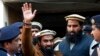 FILE - Police officers escort Zakiur Rehman Lakhvi, center, the main suspect of the Mumbai terror attacks in 2008, after his court appearance in Islamabad, Pakistan, Jan. 1, 2015.
