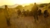 U.S. Border Patrol agents detain migrants who attempted to cross the U.S.-Mexico border undetected in a desert area outside Sunland Park, New Mexico, on June 23 2023.