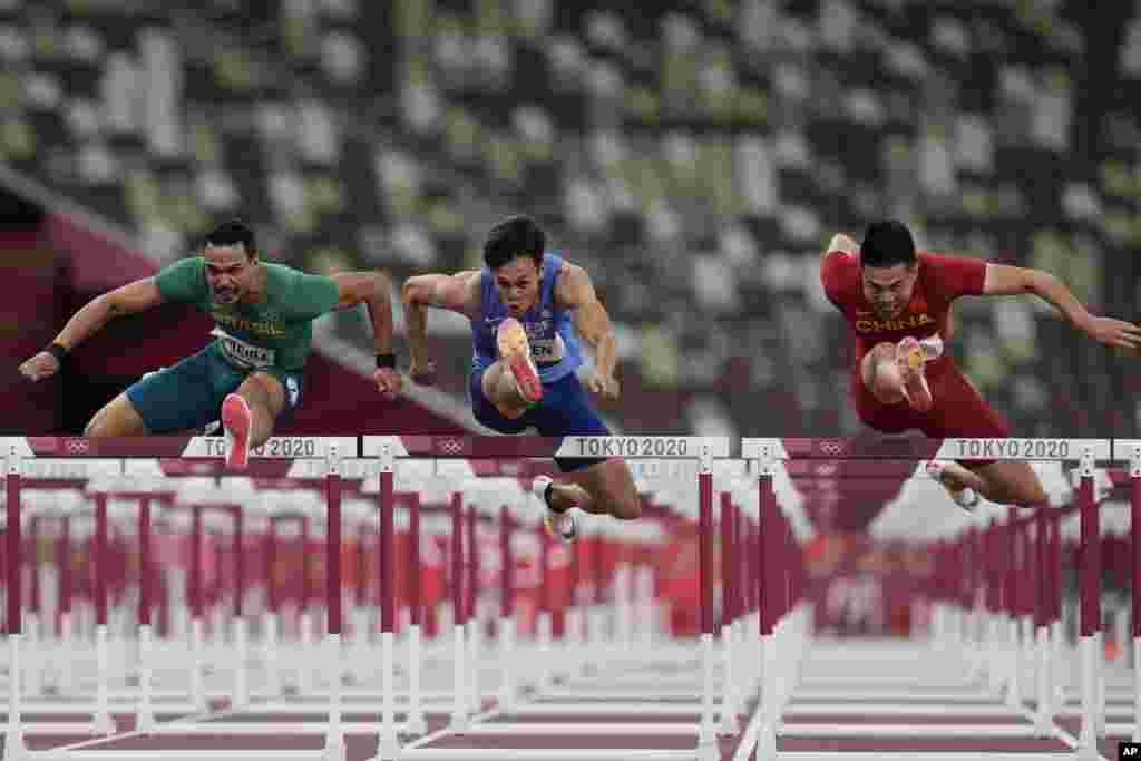 Rafael Pereira, left, of Brazil, Kuei-Ru Chen, of Taiwan, and Wenjun Xie,right, of China, compete in a heat of the men&#39;s 110-meter hurdles at the 2020 Summer Olympics, in Tokyo, Japan.