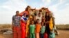 FILE - A family stands beside their shelter at a camp for internally displaced people from drought hit areas in Dollow, Somalia, April 3, 2017. 