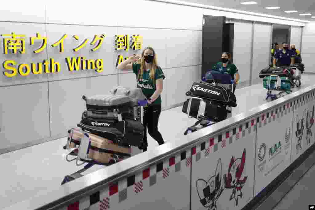 Members of Australia&#39;s Olympic softball squad, the first national team to come to Japan for pre-Olympic training camp since the Tokyo 2020 Olympic Games were postponed to 2021 due to the COVID-19 pandemic, arrive at Narita international airport in Narita, east of Tokyo.