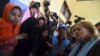U.S. Assistant Secretary of State for Population, Refugees and Migration Anne Richard, right, visits with Rohingya migrants at a temporary shelter in Kuala Cangkoi, Lhoksukon, Aceh province, Indonesia, June 2, 2015.