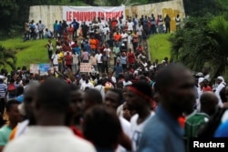 Supporters of Ivory Coast's opposition hold placards as they protest during a political rally ahead of the referendum on a new constitution, in Abidjan, Ivory Coast, Oct. 28, 2016.