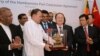 Sri Lanka's Minister of Ports & Shipping Mahinda Samarasinghe (C) exchanges souvenirs with Executive Vice President of China Merchants Port Holdings Dr. Hu Jianhua (3-R) during the Hambantota International Port Concession Agreement at a signing ceremony in Colombo, Sri Lanka, July 29, 2017. 