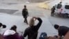 Agent granične patrole gleda kako se migranti pakuju nakon što su ilegalno prešli i čekali da podnose zahtjev za azil između dva granična zida koja razdvajaju Meksiko i Sjedinjene Države, u utorak, 21. januara 2025, u San Diegu. (Foto: AP /Gregory Bull)