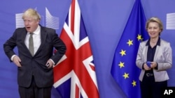 European Commission President Ursula von der Leyen, right, welcomes British Prime Minister Boris Johnson prior to a meeting at EU headquarters in Brussels, Wednesday, Dec. 9, 2020.