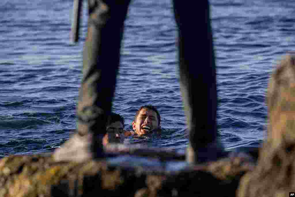 A Spanish civil guard waits for migrants at the Spanish enclave of Ceuta, near the border of Morocco and Spain. Spanish officials say the migrant crisis was triggered by Madrid&#39;s decision to provide medical treatment to the militant boss of the Polisario 
