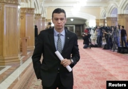 FILE - Romania's Prime Minister Sorin Grindeanu leaves a meeting of the Social Democrat Party (PSD) at the parliament in Bucharest, Romania, Feb. 6, 2017.
