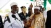 FILE - Kwire-Mana (R), receives his staff of office from Adamawa State Governor Murtala Nyako during a presentation ceremony at Makwada Square in Numan, Adamawa state, Dec. 7, 2013. 