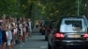 People pay their respects as a convoy of hearses, bearing remains of the victims of the Malaysia Airlines Flight MH17 crash, drive past in Hilversum, Netherlands, July 23, 2014. 