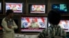 People watch Indian Prime Minister Narendra Modi addressing the nation, on television in Hyderabad, India, Saturday, Dec. 31, 2016. 