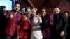 Democratic presidential candidate Hillary Clinton, center, pose with members of the band Los Tigres del Norte at a debate watch party at the Craig Ranch Regional Amphitheater in North Las Vegas, Oct. 19, 2016.