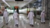 FILE - Staff of the Pyongyang Department Store No. 1 disinfect the store to help curb the spread of the coronavirus before it opens in Pyongyang, North Korea, Dec. 28, 2020. 
