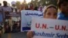 Pakistani Kashmiris carry placards to show their solidarity with Indian Kashmiri Muslims during an anti-Indian protest in Islamabad, Sept. 26, 2016.
