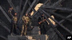 Insurgent fighters celebrate in the aftermath of the opposition's takeover of the city in downtown Hama, Syria, Dec. 6, 2024. 