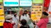 Staff sell masks at a Yifeng Pharmacy in Wuhan, Chin, Jan. 22, 2020. 