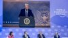 TotalEnergies chairman and CEO Patrick Pouyanne (2ndR) asks a question to US President Donald Trump (on screen) during his address by video conference at the World Economic Forum (WEF) annual meeting in Davos on January 23, 2025.