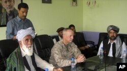 The commander of U.S. and NATO troops in Afghanistan, General John Allen (C) meets with the Governor of Logar Province, Allhaj Mohammad Tahir Sabari (L) south of Kabul, Afghanistan, June 8, 2012. 