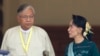 Htin Kyaw, center, newly elected president of Myanmar, walks with National League for Democracy leader Aung San Suu Kyi, right, at Myanmar's parliament in Naypyitaw, Myanmar, Tuesday, March 15, 2016. 