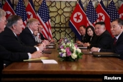 North Korea's leader Kim Jong Un and U.S. President Donald Trump attend the extended bilateral meeting in the Metropole hotel with their advisers.
